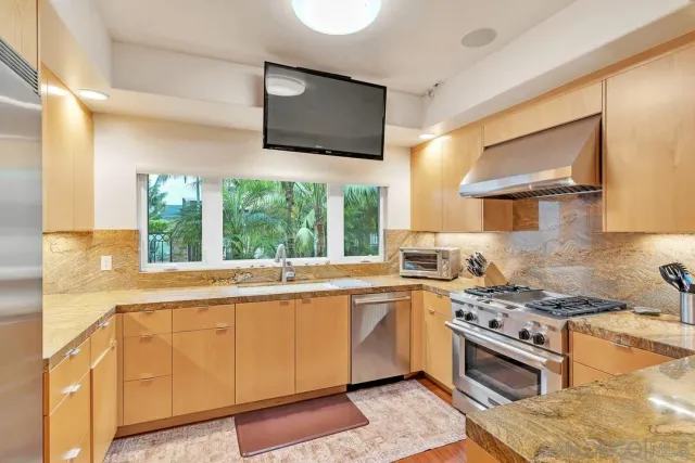 a kitchen with a stove a sink and a microwave