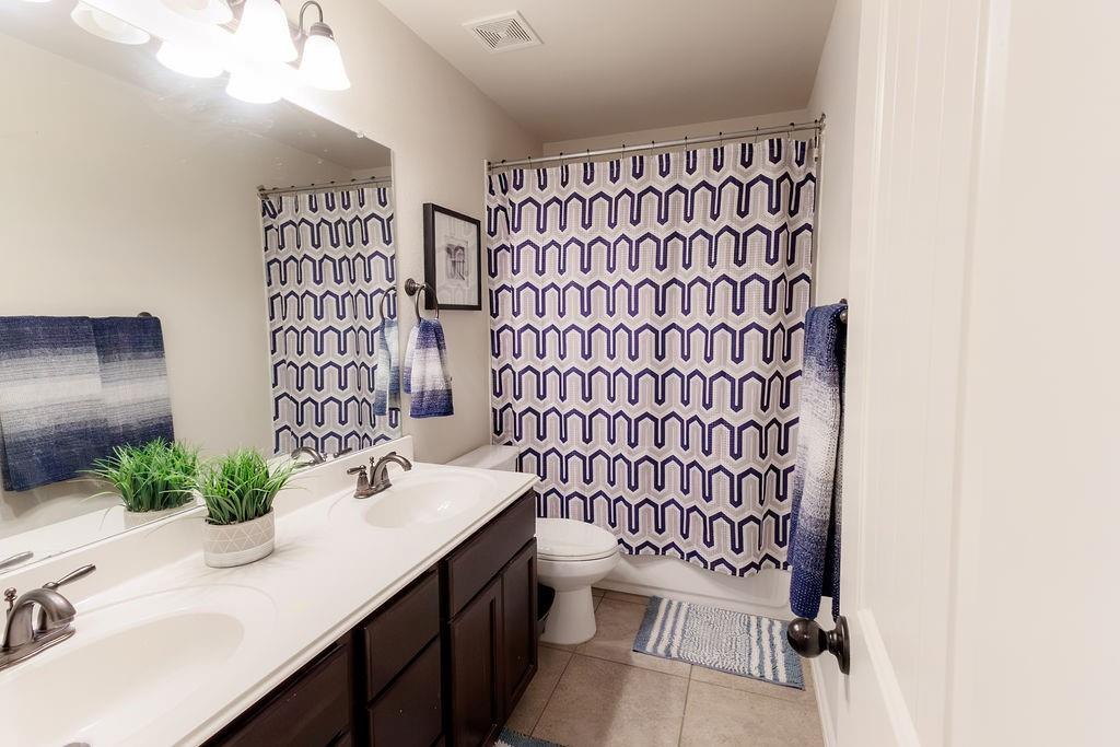 544 Madrone Trail Forney, TX 75126 - Photo 14 of 23 a bathroom with a sink toilet and shower