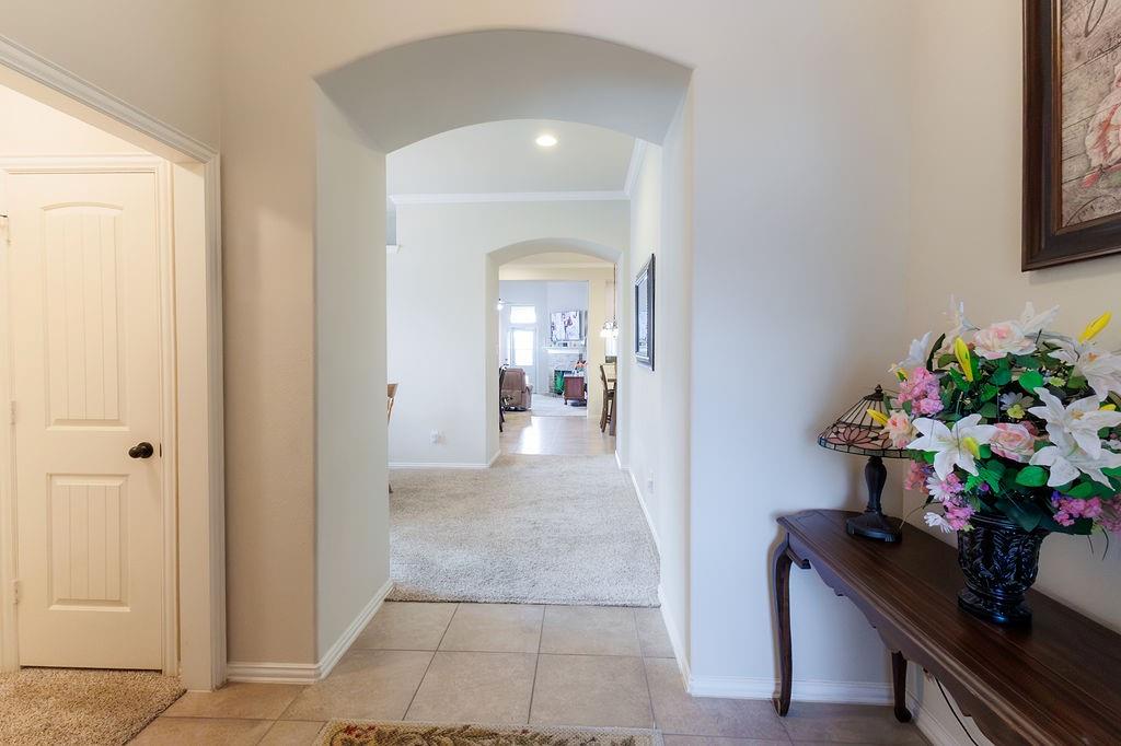 544 Madrone Trail Forney, TX 75126 - Photo 3 of 23 a view of a hallway to a livingroom with furniture