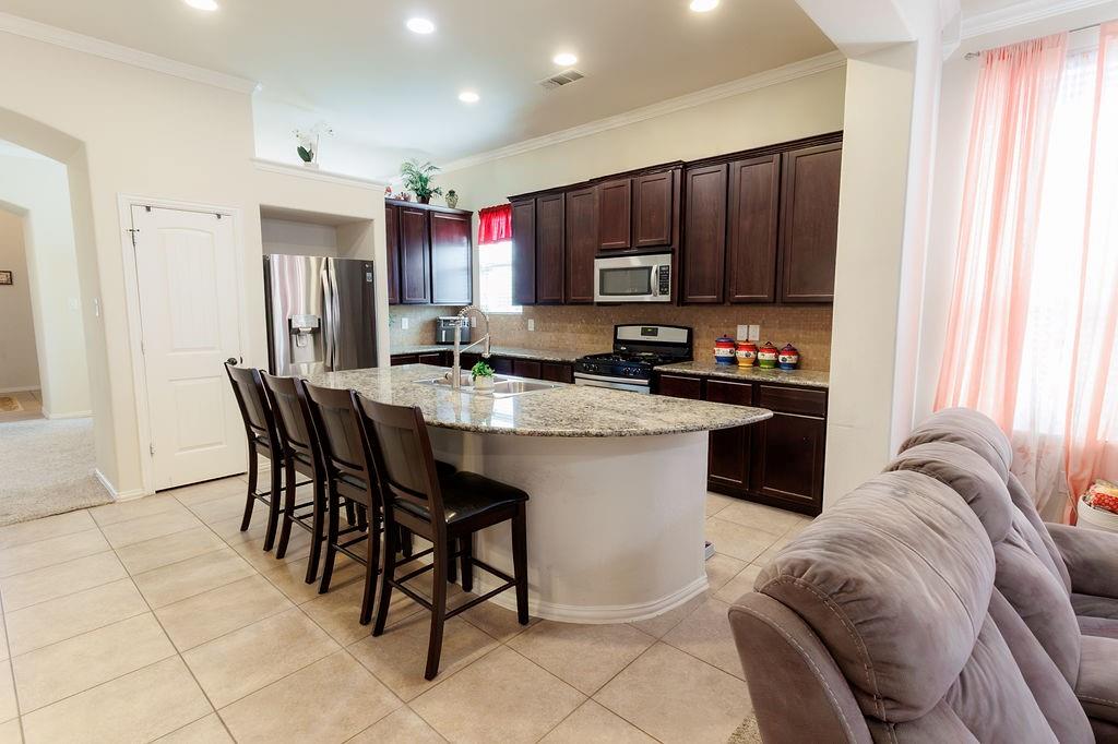 544 Madrone Trail Forney, TX 75126 - Photo 9 of 23 a kitchen with a sink refrigerator and cabinets