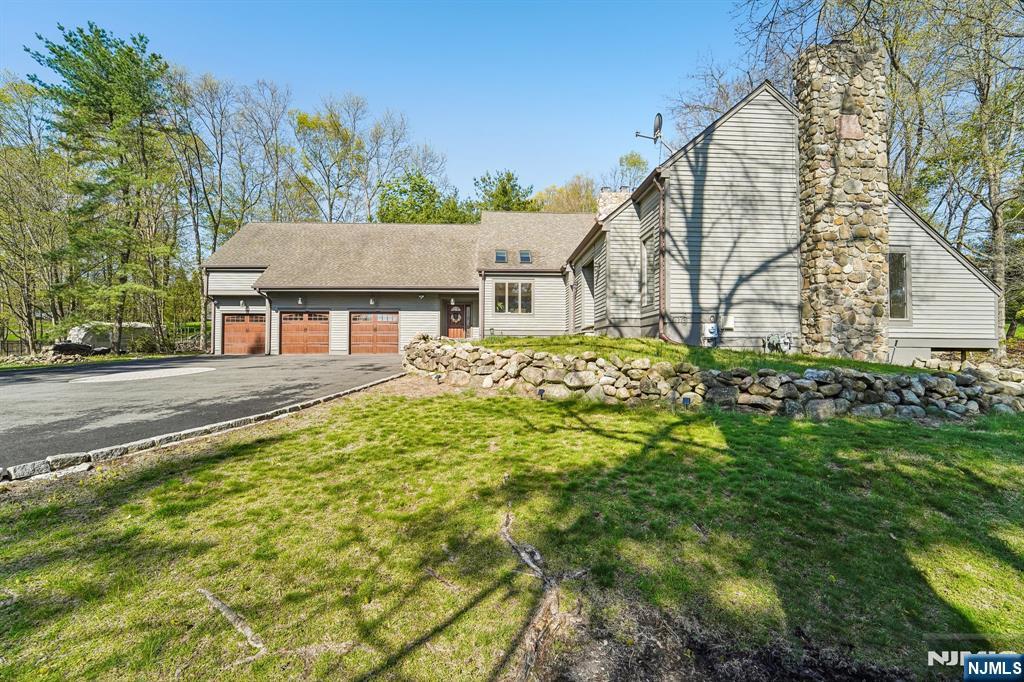 11 Carlough Road Upper Saddle River, NJ 07458 - Photo 3 of 41 a house view with a garden space