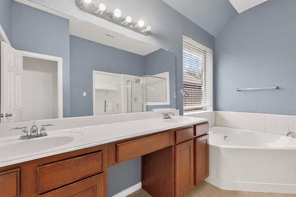 1122 Leafy Glade Road Forney, TX 75126 - Photo 11 of 19 a bathroom with a tub sink and mirror