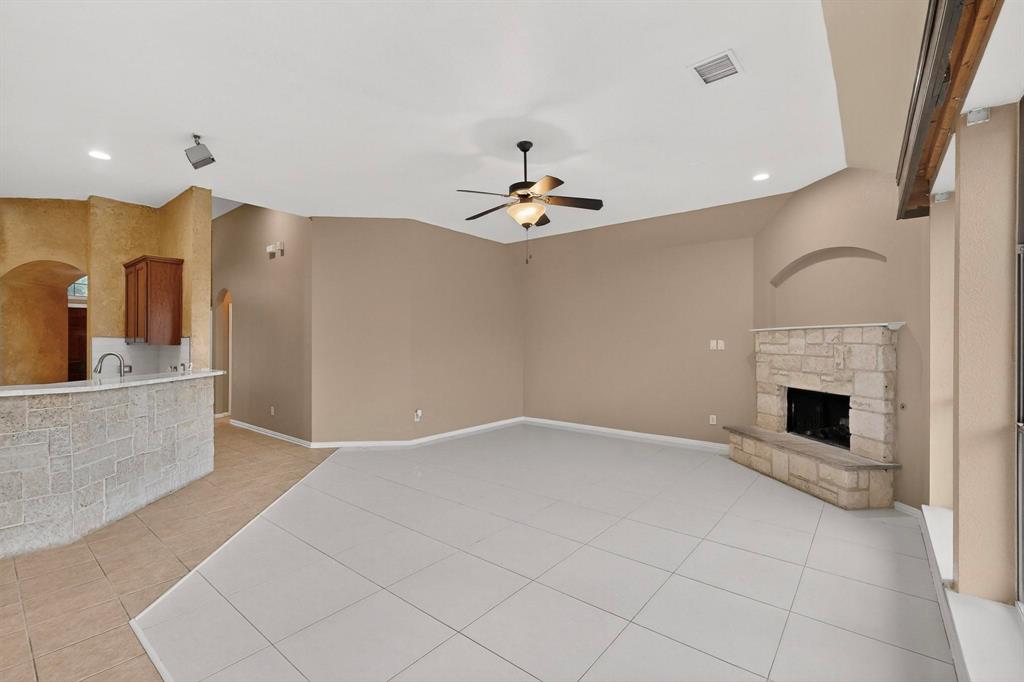 1122 Leafy Glade Road Forney, TX 75126 - Photo 4 of 19 an empty room with fireplace and windows