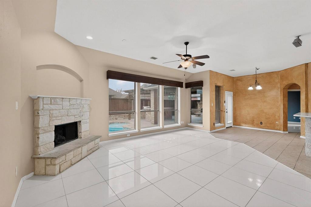 1122 Leafy Glade Road Forney, TX 75126 - Photo 5 of 19 a view of an empty room with chandelier fan and fire place
