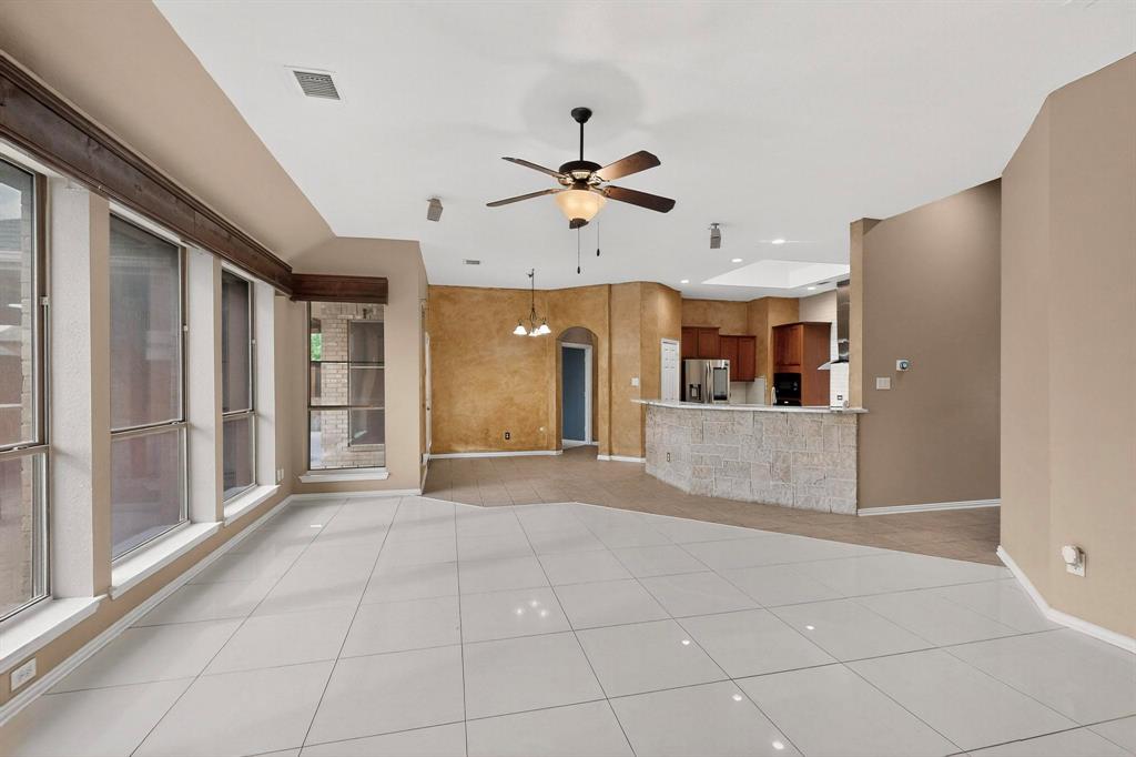 1122 Leafy Glade Road Forney, TX 75126 - Photo 6 of 19 a view of a kitchen with furniture and a ceiling fan