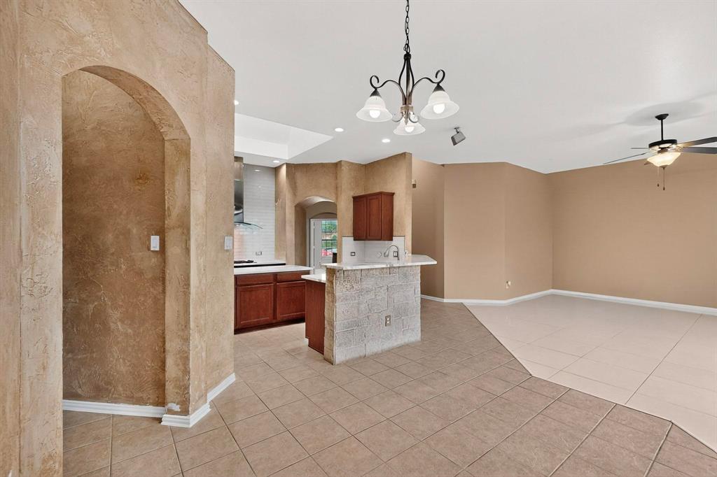 1122 Leafy Glade Road Forney, TX 75126 - Photo 7 of 19 a view of a kitchen with a sink and dishwasher a kitchen island with wooden floor