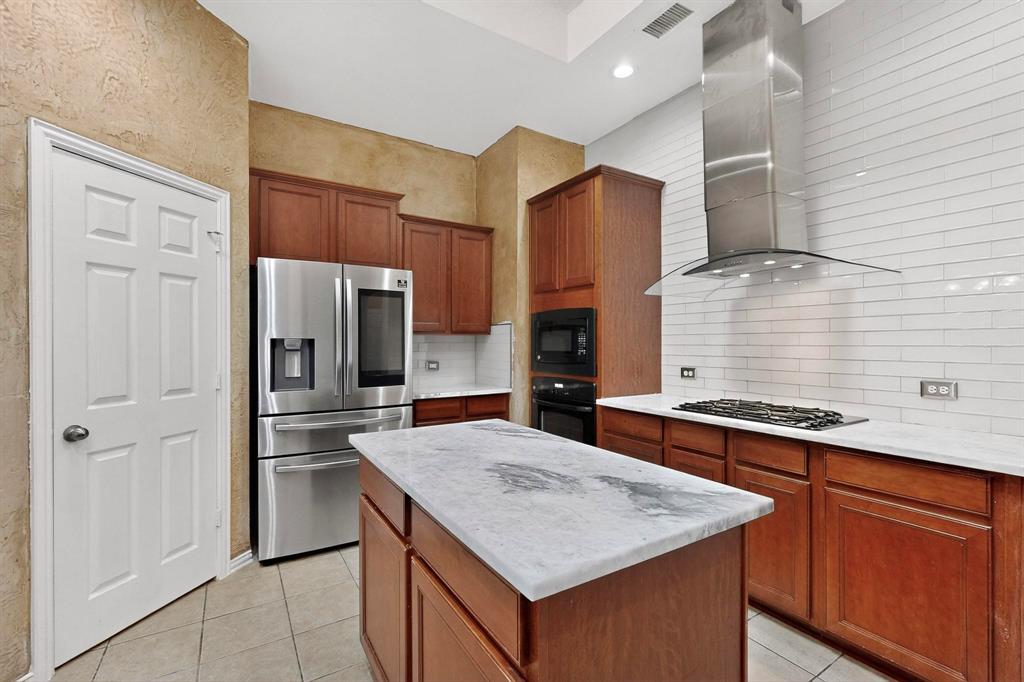 1122 Leafy Glade Road Forney, TX 75126 - Photo 8 of 19 a kitchen with stainless steel appliances a sink and a refrigerator