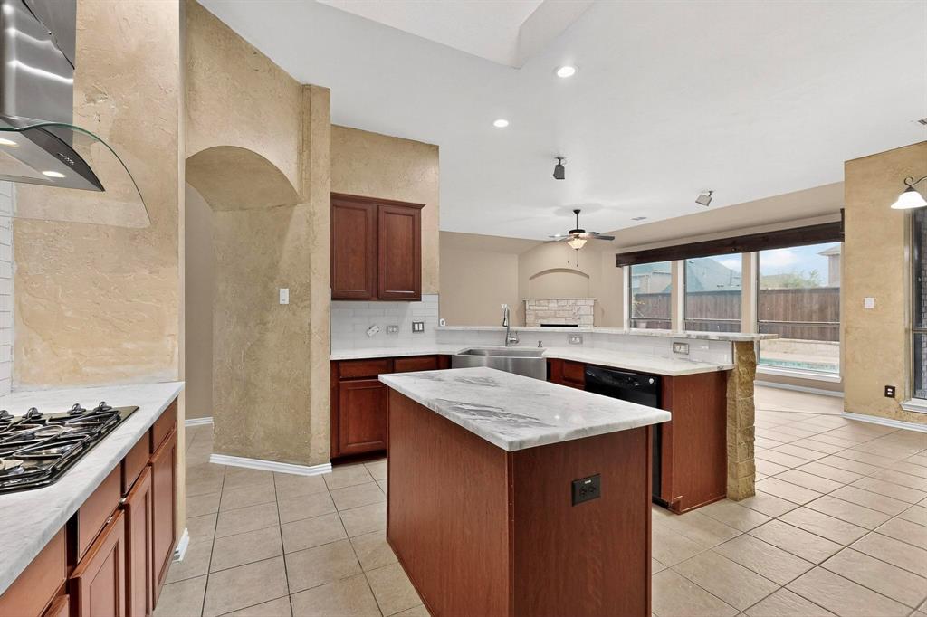 1122 Leafy Glade Road Forney, TX 75126 - Photo 9 of 19 a kitchen with a counter top a sink stainless steel appliances and cabinets