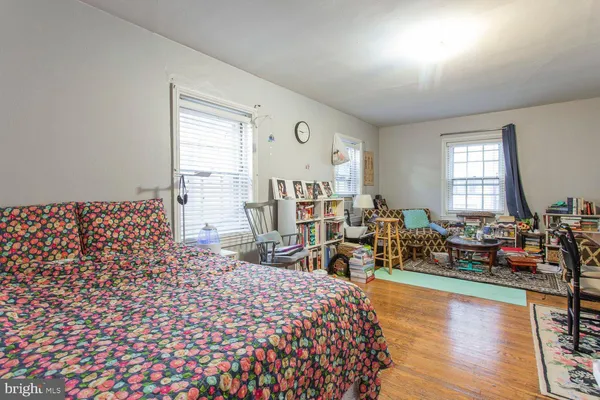 a living room with furniture window and wooden floor