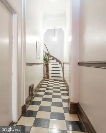a view of a hallway with white checkered floor and a black white checkered floor