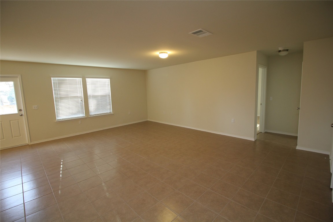 9001 Tall Sky Trc Austin, TX 78724 - Photo 2 of 4 Tiled spare room featuring baseboards