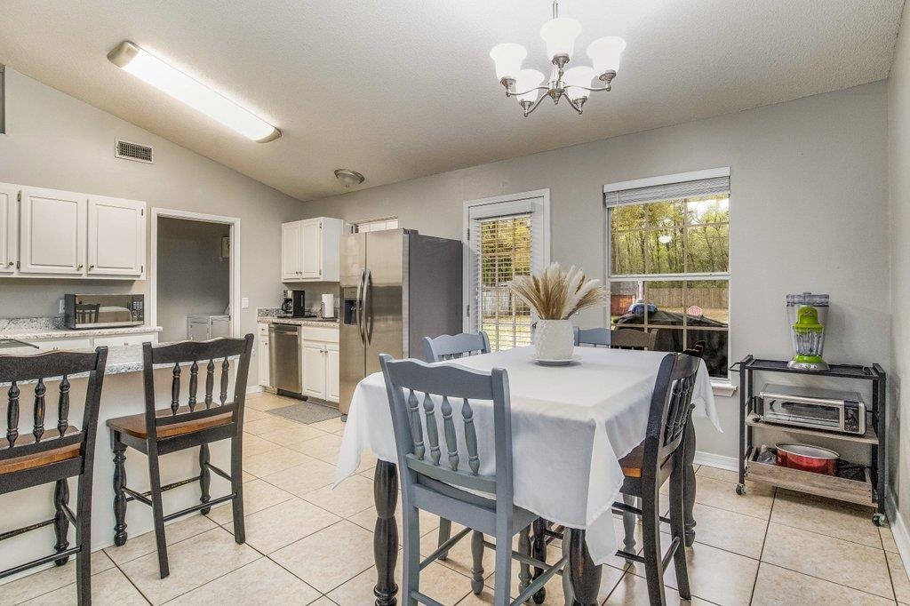 6612 Ridge Crest Drive Milton, FL 32570 - Photo 10 of 47 Dining area with peninsula barstool seating