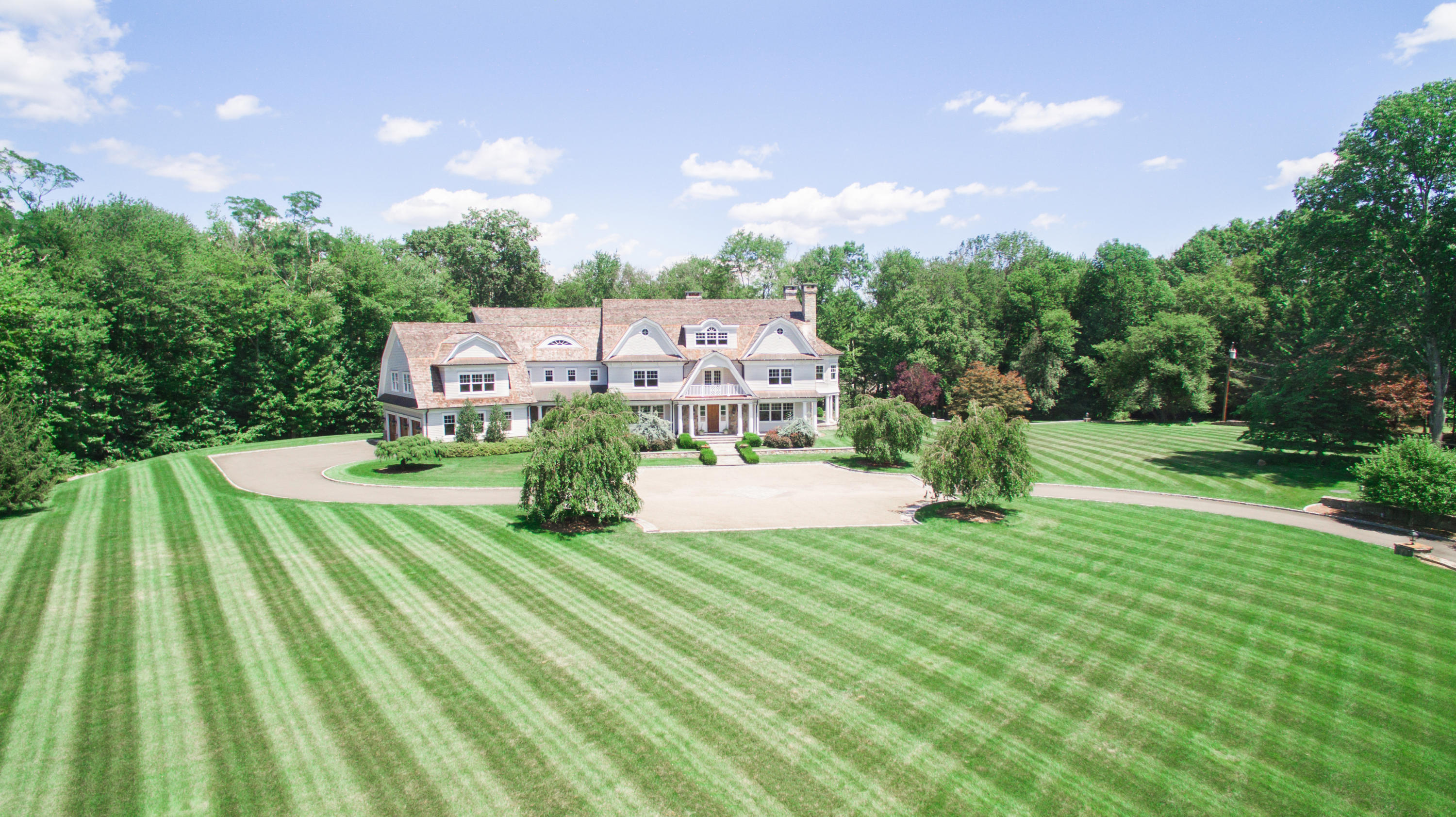 1385 Smith Ridge Road New Canaan, CT 06840 - Photo 1 of 33 a view of a house with a swimming pool