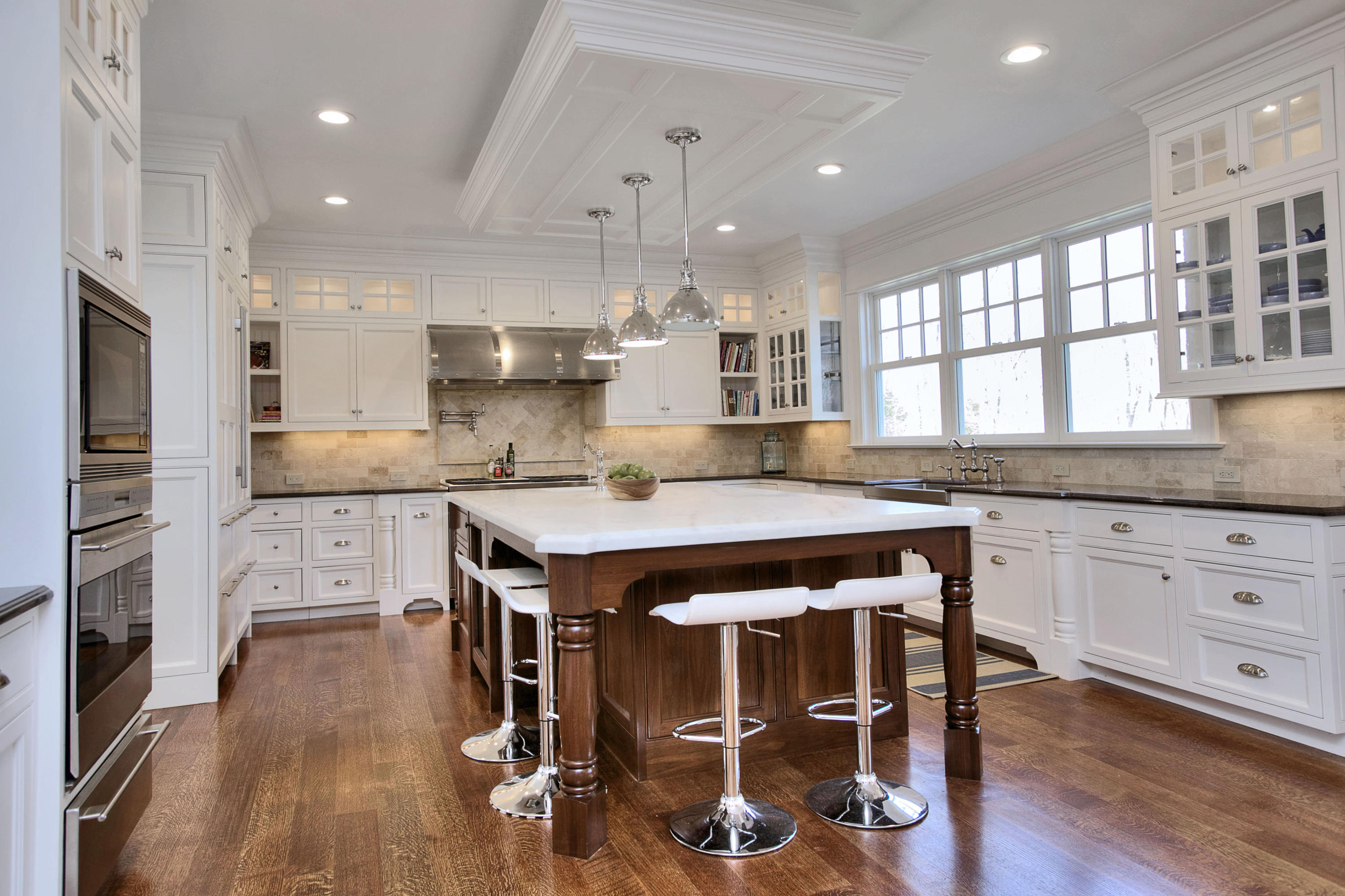 1385 Smith Ridge Road New Canaan, CT 06840 - Photo 11 of 33 a kitchen with kitchen island a stove a sink a refrigerator and white cabinets with wooden floor