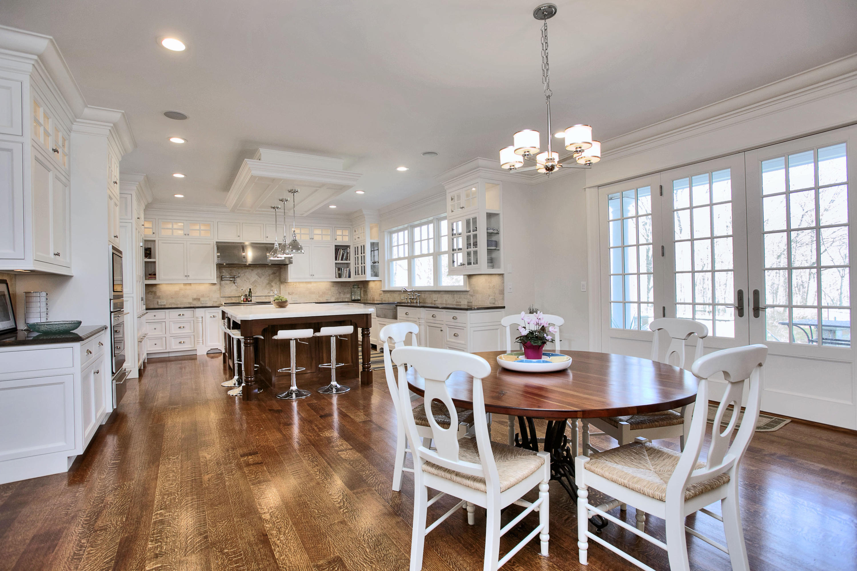 1385 Smith Ridge Road New Canaan, CT 06840 - Photo 12 of 33 a dining room with furniture a chandelier and wooden floor