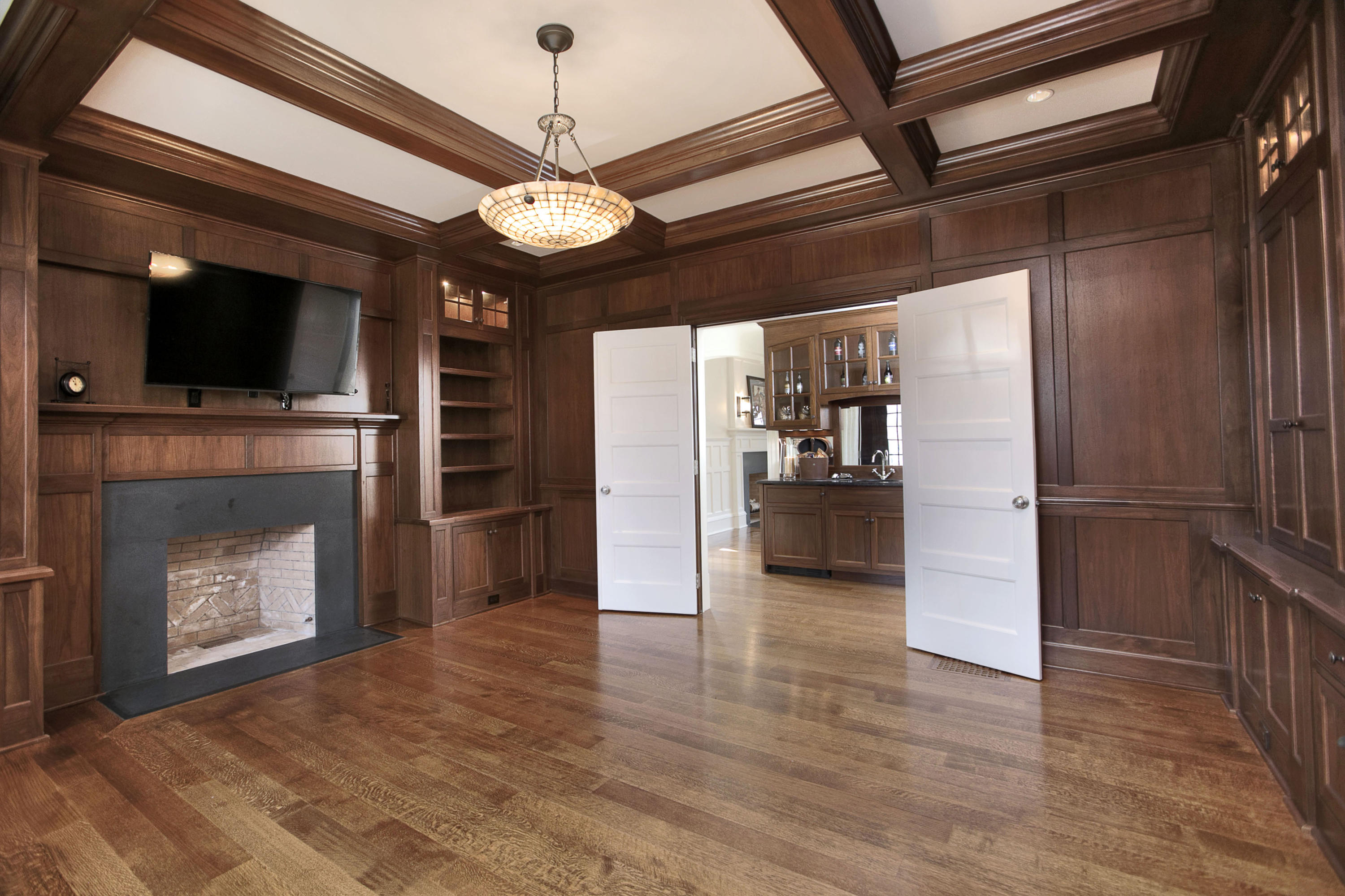 1385 Smith Ridge Road New Canaan, CT 06840 - Photo 15 of 33 a view of a livingroom with a fireplace a flat screen tv and refrigerator