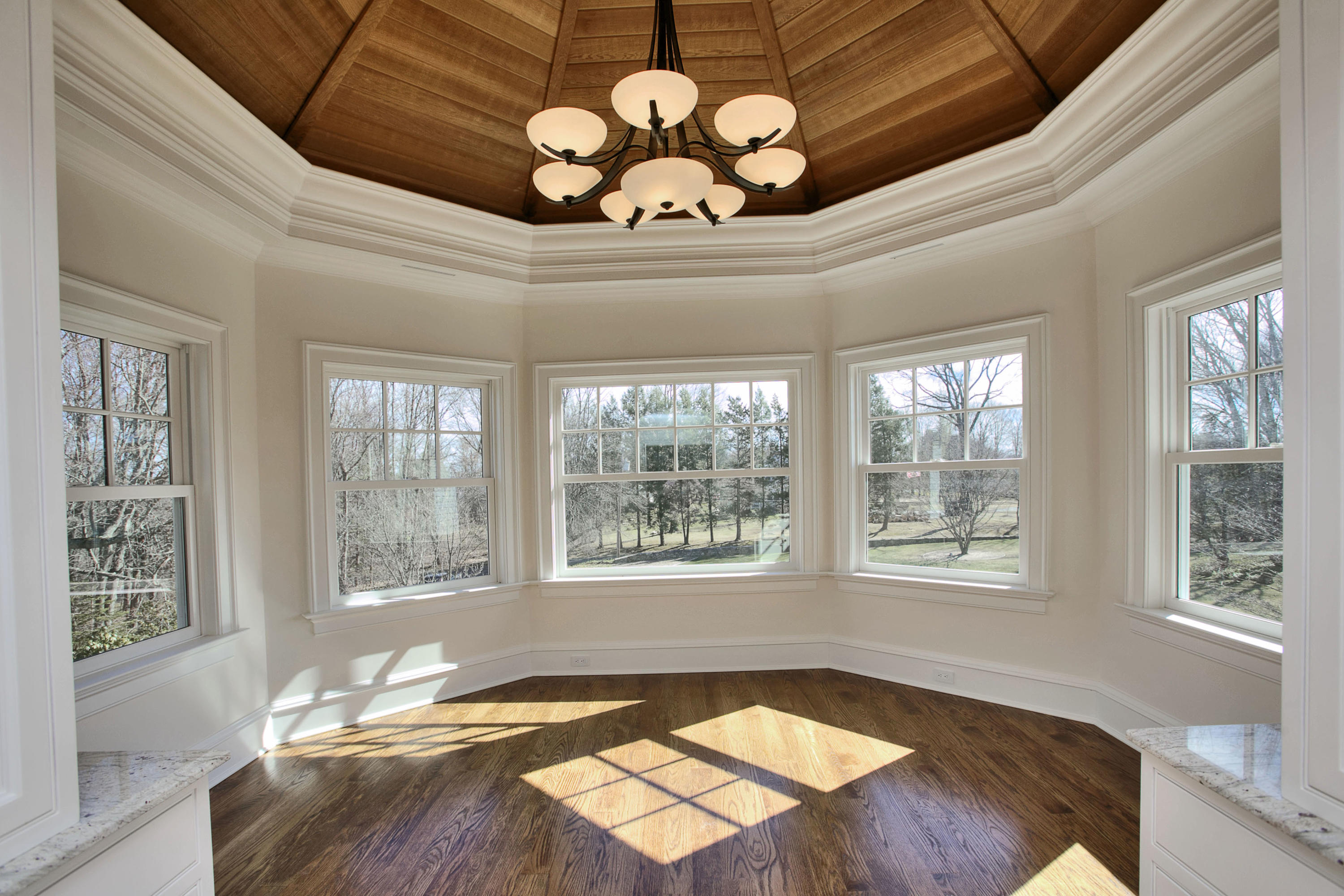1385 Smith Ridge Road New Canaan, CT 06840 - Photo 20 of 33 a view of a livingroom with a chandelier fan and windows