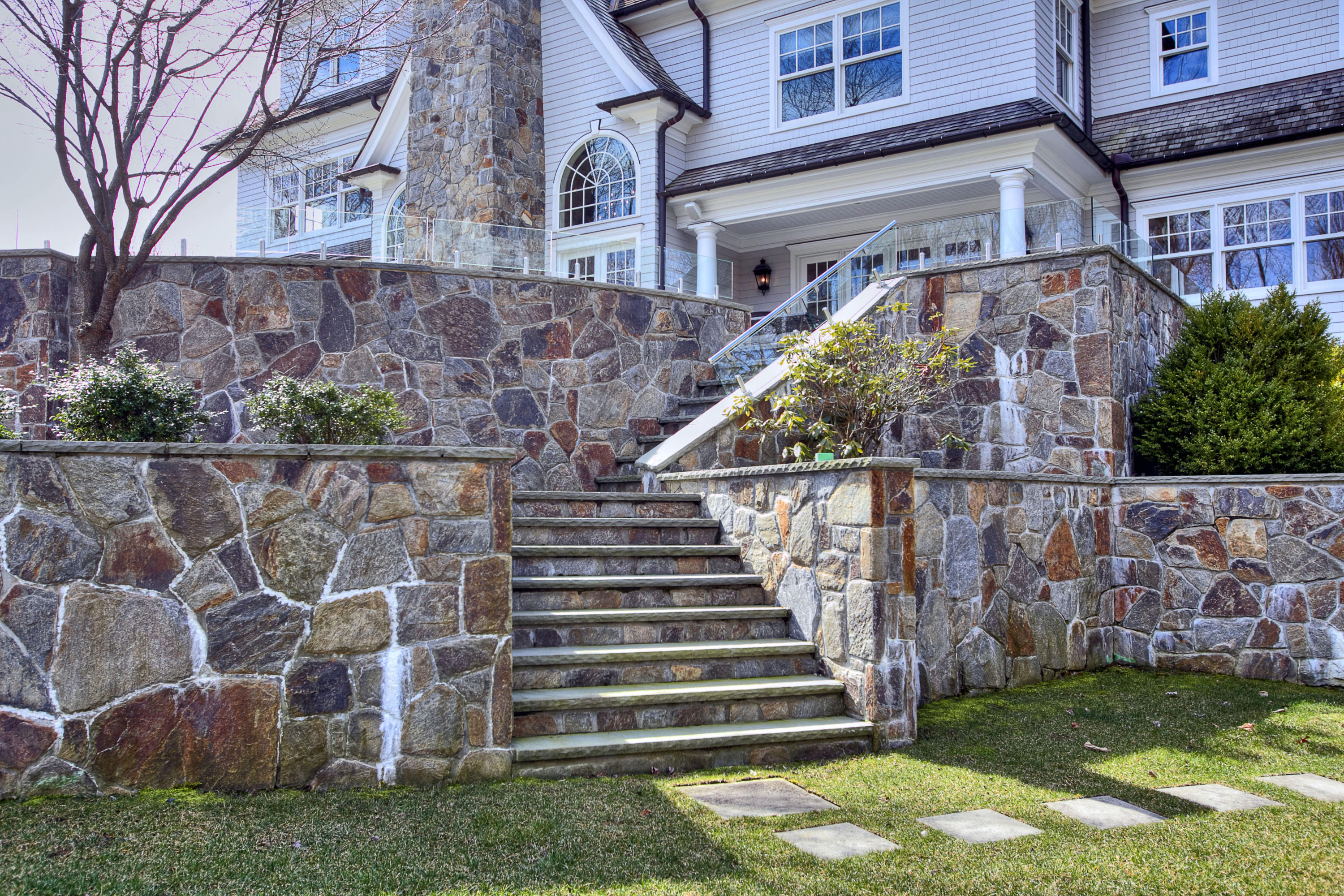 1385 Smith Ridge Road New Canaan, CT 06840 - Photo 29 of 33 a view of a brick house with a small yard and a large tree