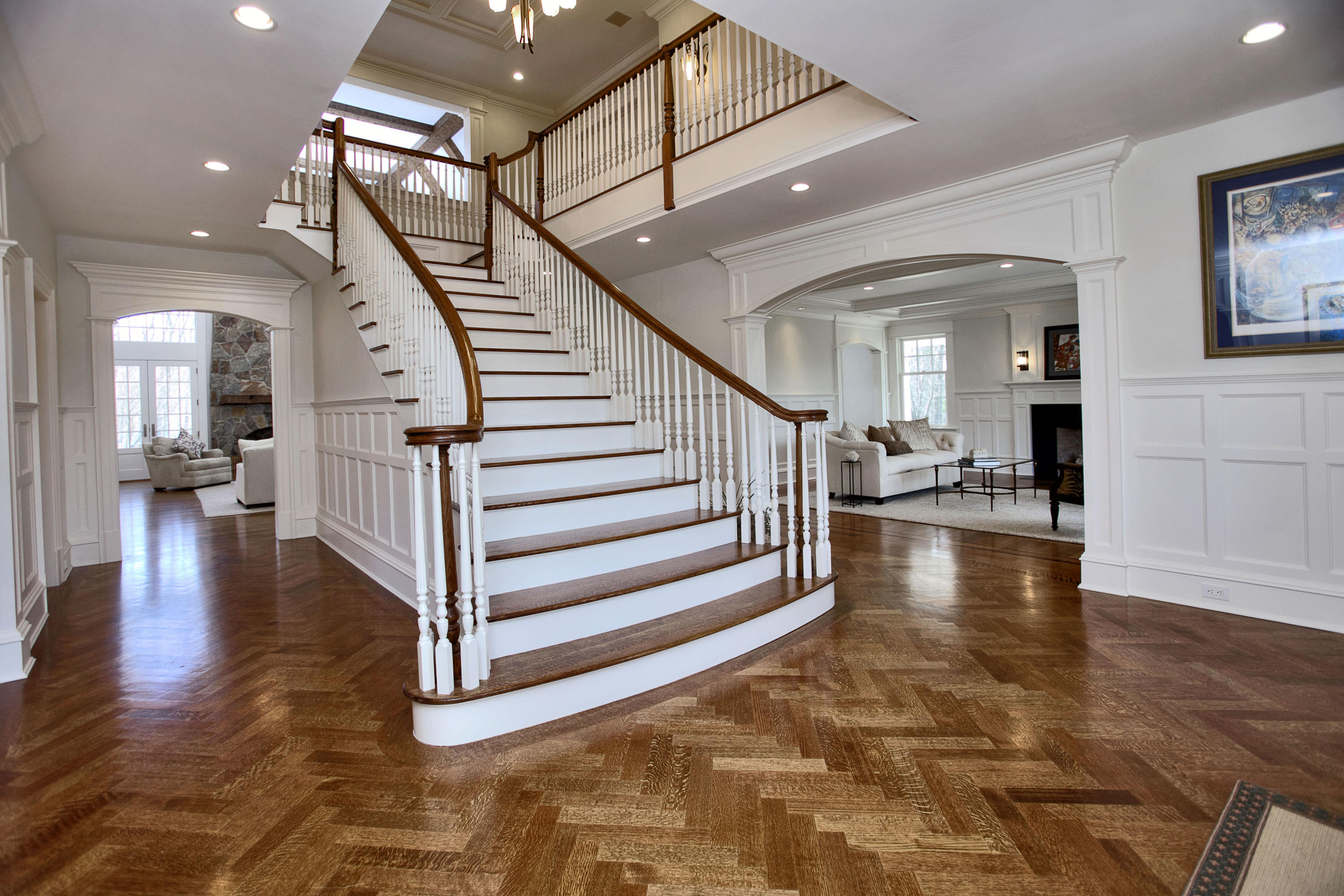 1385 Smith Ridge Road New Canaan, CT 06840 - Photo 3 of 33 a view of a hallway with stairs to ceiling window and wooden floor