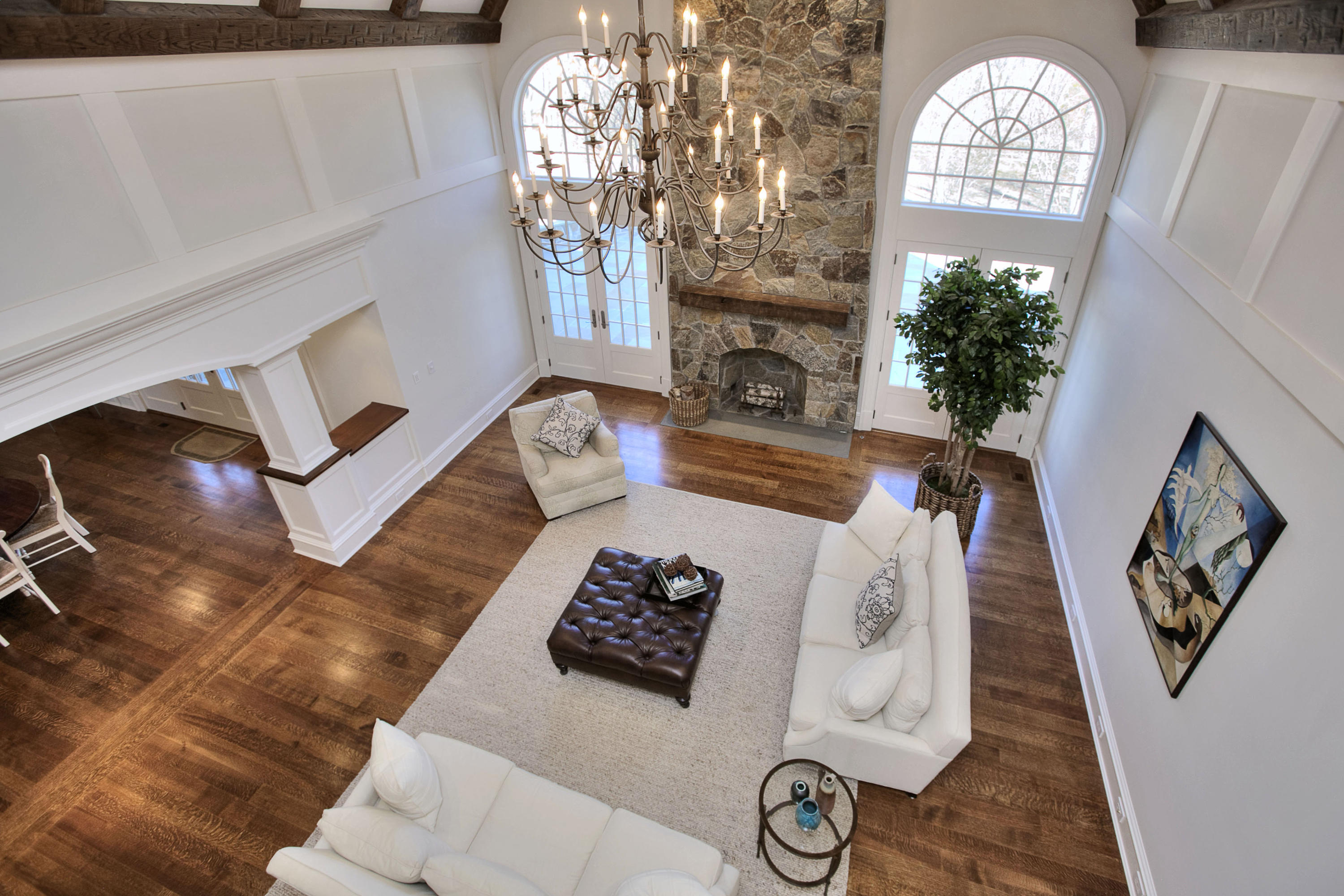 1385 Smith Ridge Road New Canaan, CT 06840 - Photo 4 of 33 a living room with furniture a fireplace and a chandelier