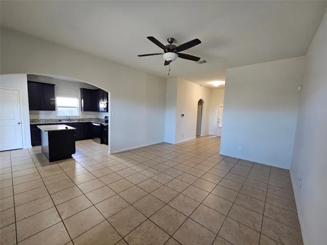 a kitchen with granite countertop a sink and a stove top oven
