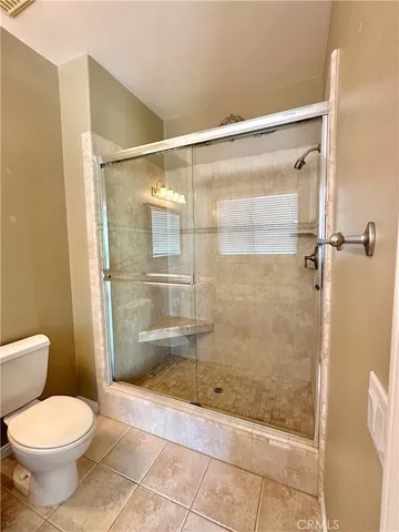 a bathroom with a shower and a toilet