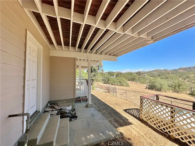 a view of balcony with wooden floor and mountain view