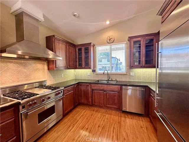a kitchen with stainless steel appliances granite countertop a stove and a sink