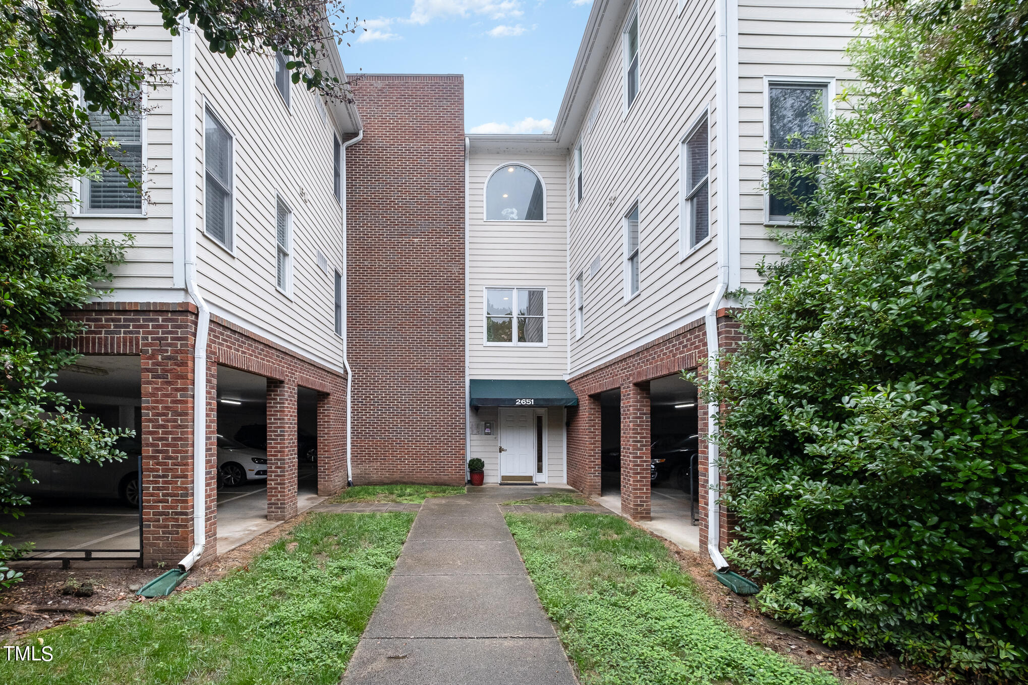 2651 Mellowfield Drive, Unit 107 Raleigh, NC 27604 - Photo 1 of 15 a front view of a house with a yard and an outdoor space
