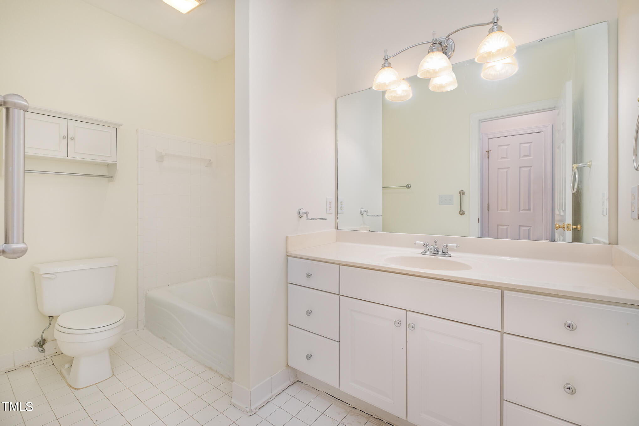 2651 Mellowfield Drive, Unit 107 Raleigh, NC 27604 - Photo 11 of 15 a bathroom with a toilet a sink and mirror