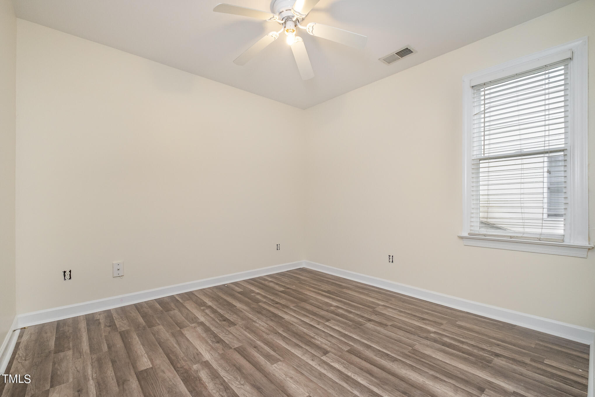 2651 Mellowfield Drive, Unit 107 Raleigh, NC 27604 - Photo 13 of 15 a view of a room with wooden floor and fan