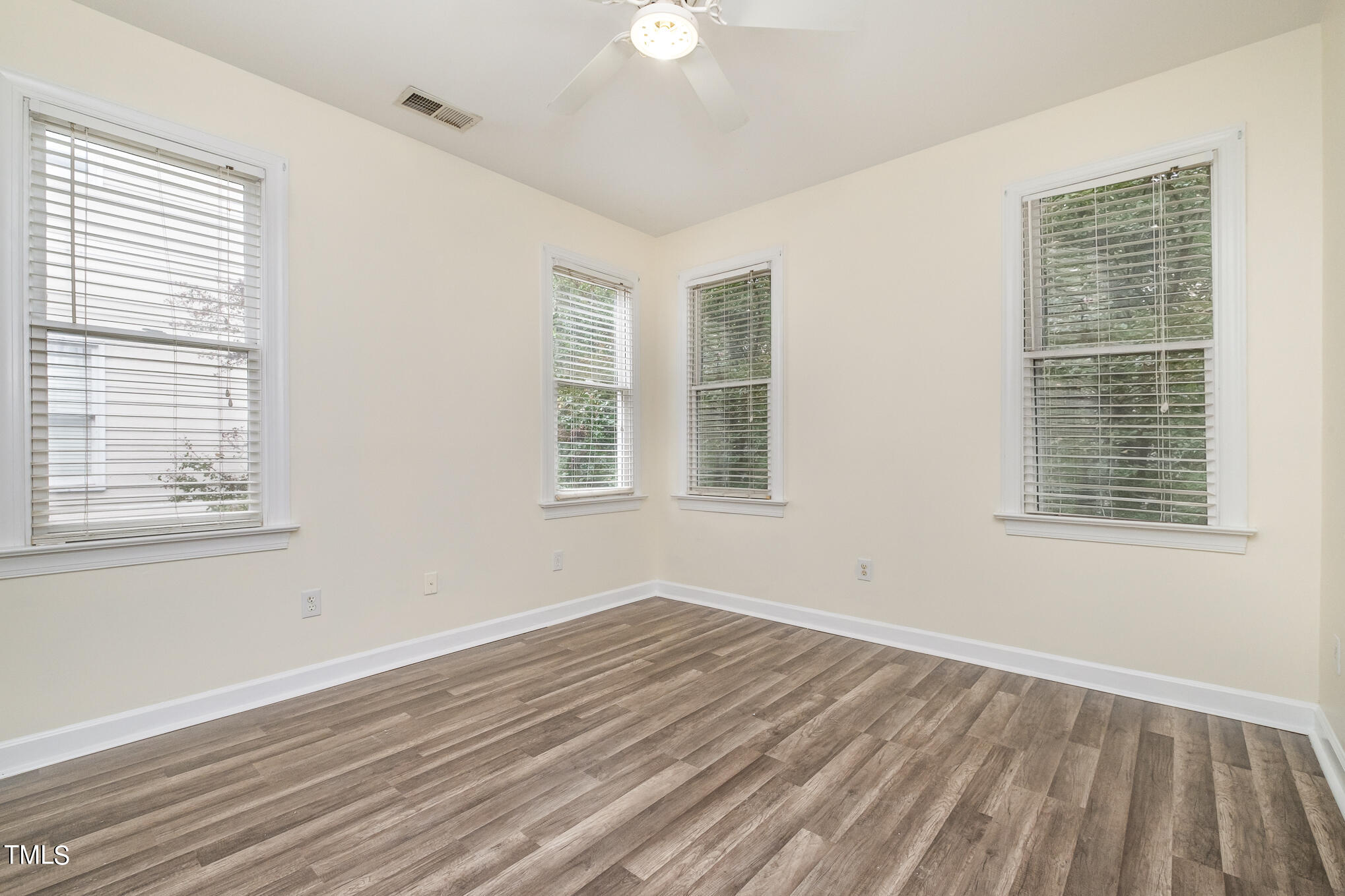 2651 Mellowfield Drive, Unit 107 Raleigh, NC 27604 - Photo 14 of 15 a view of empty room with wooden floor and fan