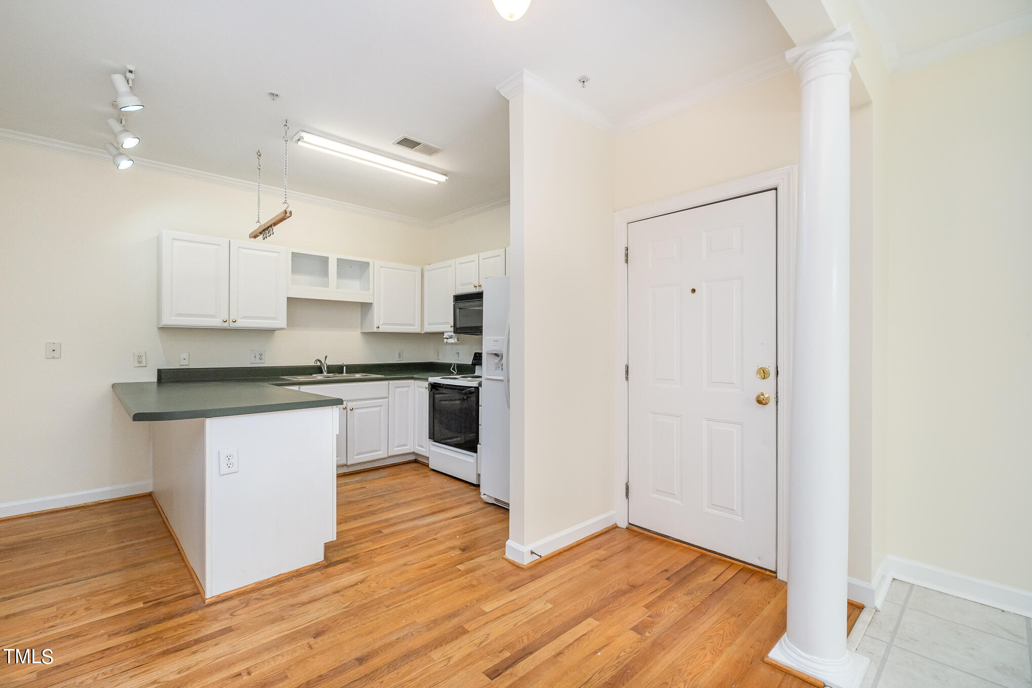2651 Mellowfield Drive, Unit 107 Raleigh, NC 27604 - Photo 2 of 15 a kitchen with granite countertop a refrigerator and white cabinets