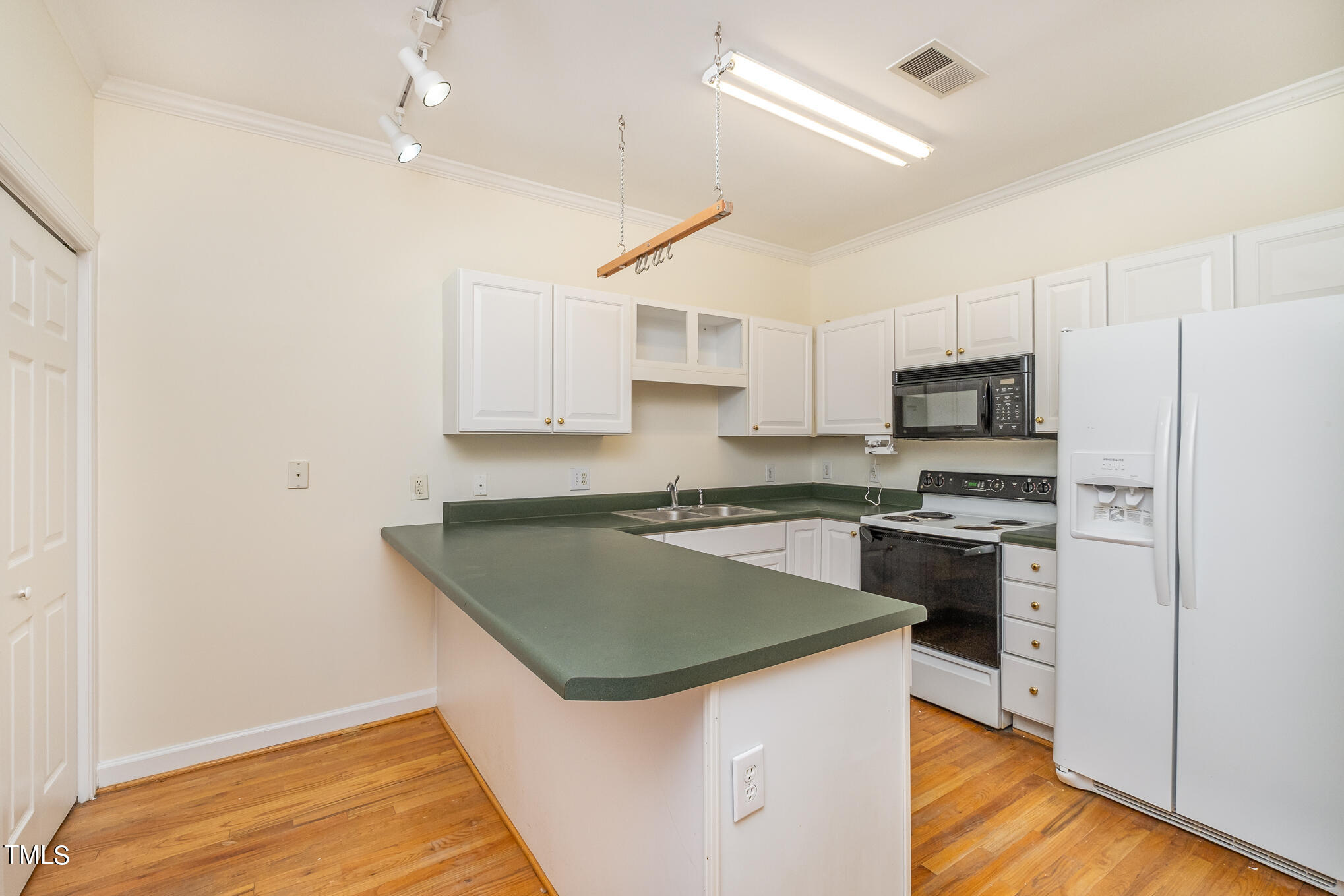 2651 Mellowfield Drive, Unit 107 Raleigh, NC 27604 - Photo 3 of 15 a kitchen that has a sink and a stove top oven