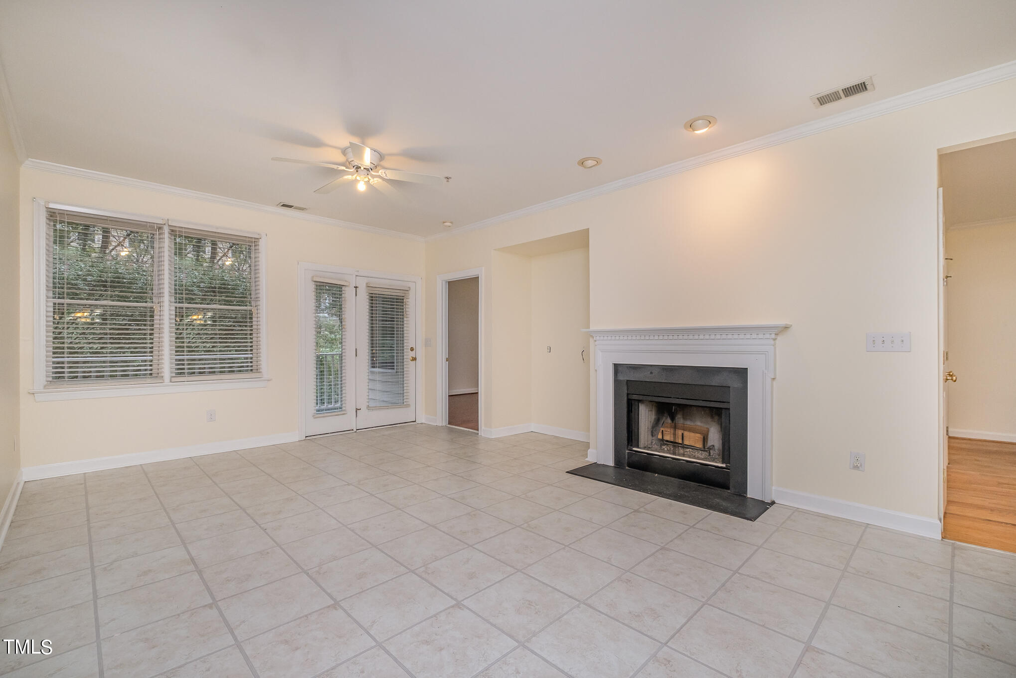 2651 Mellowfield Drive, Unit 107 Raleigh, NC 27604 - Photo 6 of 15 wooden floor fireplace and windows in an empty room