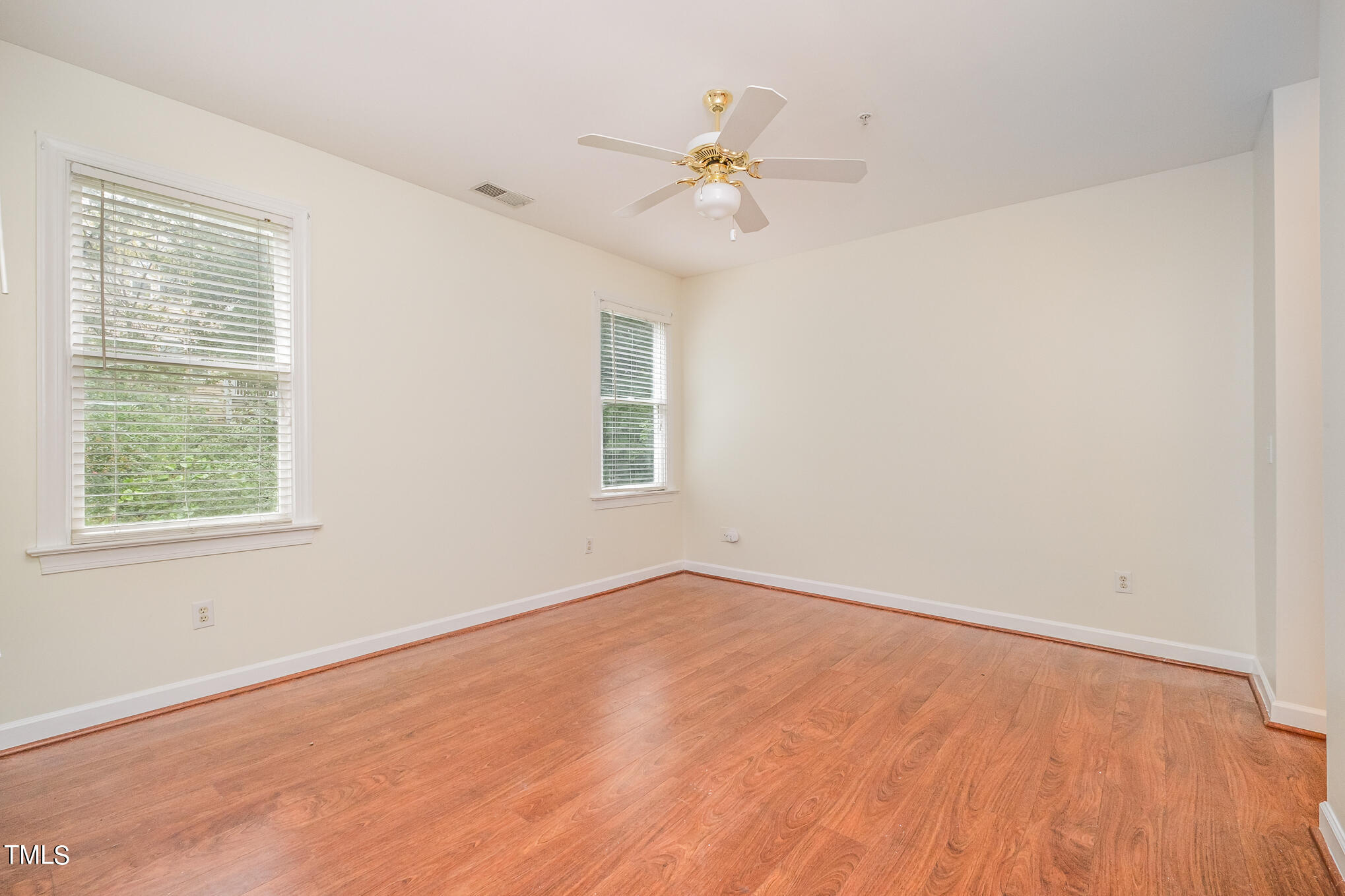 2651 Mellowfield Drive, Unit 107 Raleigh, NC 27604 - Photo 9 of 15 an empty room with a window and a fan