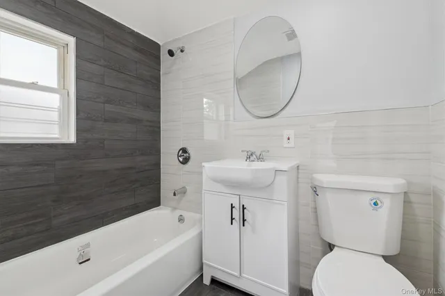 a bathroom with a sink toilet and bathtub