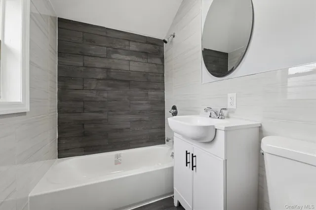 a bathroom with a sink a toilet and bathtub