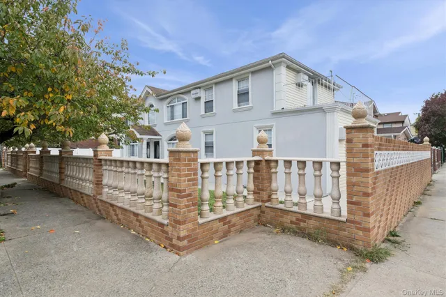 a front view of a house with wooden fence