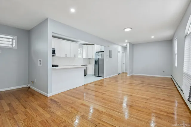 a view of a kitchen with a sink and a refrigerator