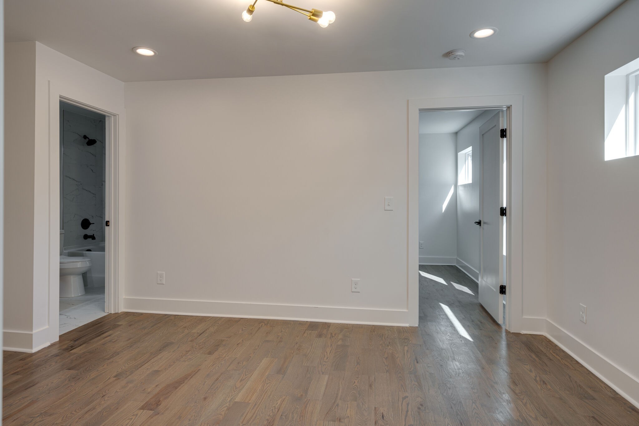 2005 Overby Road Nashville, TN 37207 - Photo 6 of 36 an empty room with wooden floor and a bathroom