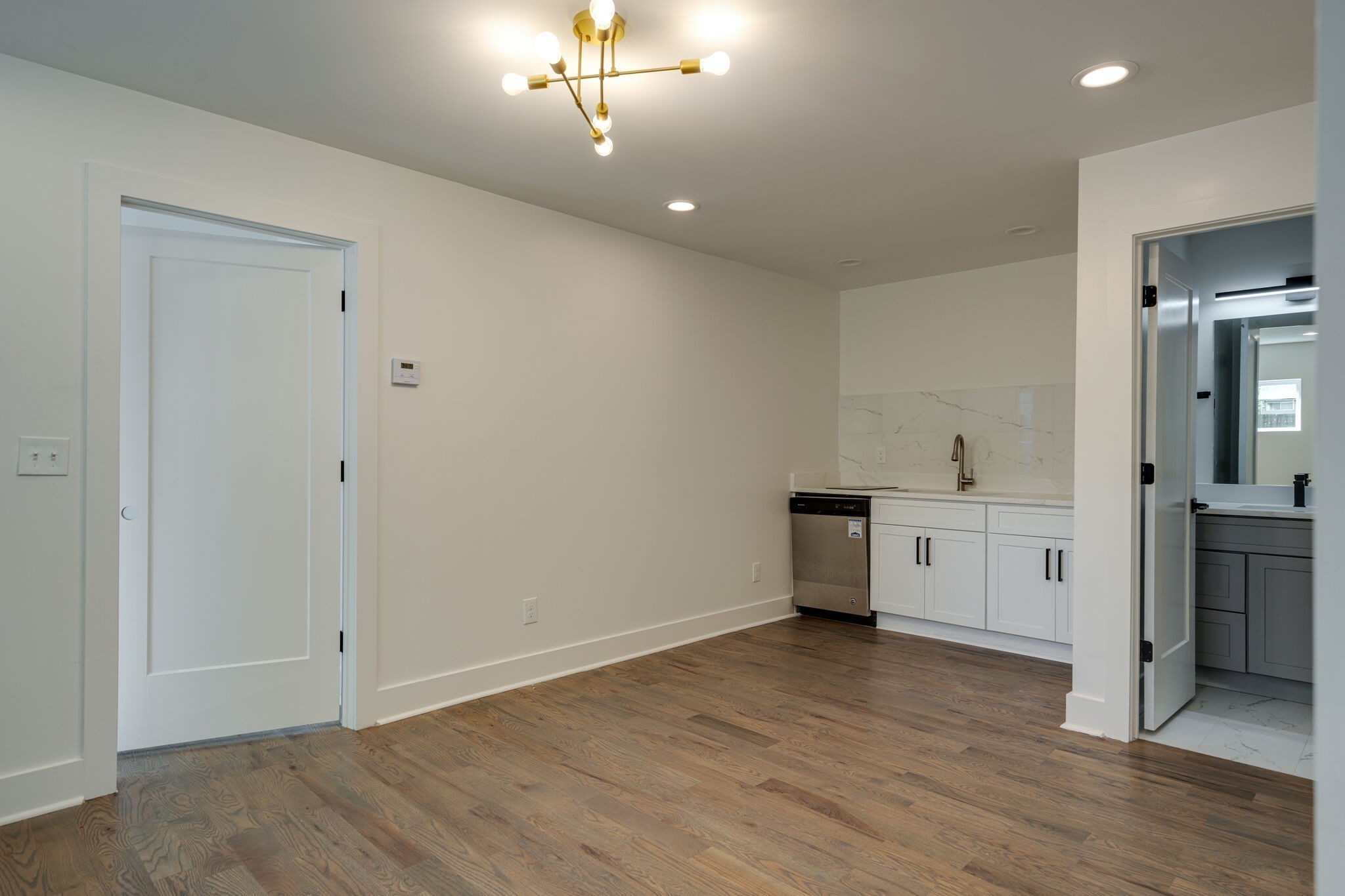 2005 Overby Road Nashville, TN 37207 - Photo 7 of 36 wooden floor in an empty room with a kitchen