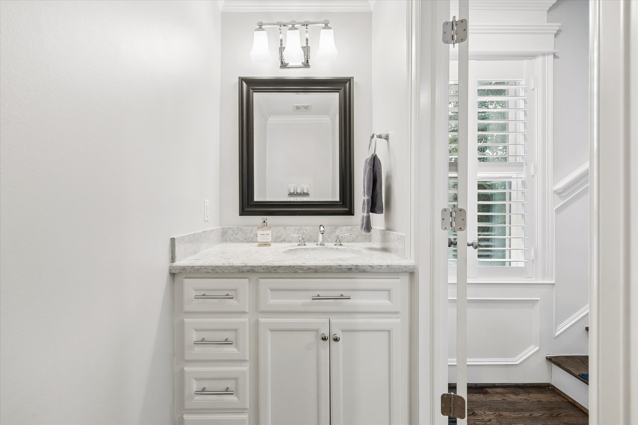 609 Rutland Street, Unit A Houston, TX 77007 - Photo 14 of 30 a bathroom with a granite countertop sink and a mirror