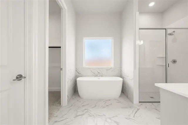 a spacious bathroom with a bathtub and shower