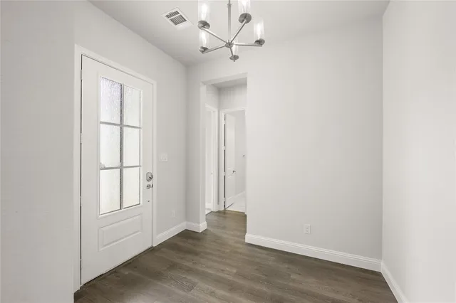 an empty room with a window and a ceiling fan