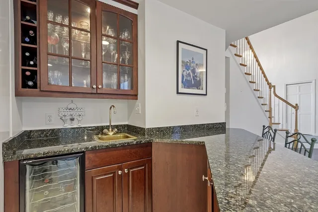 a kitchen with stainless steel appliances granite countertop a stove a sink a dining table and chairs