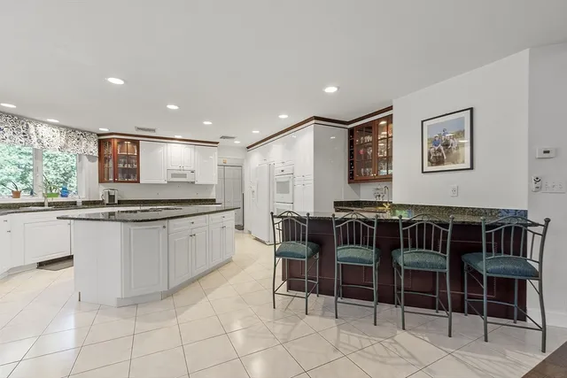 a kitchen with stainless steel appliances a counter space and a window