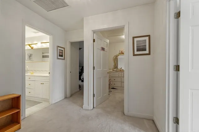 a bathroom with a granite countertop sink mirror vanity and toilet