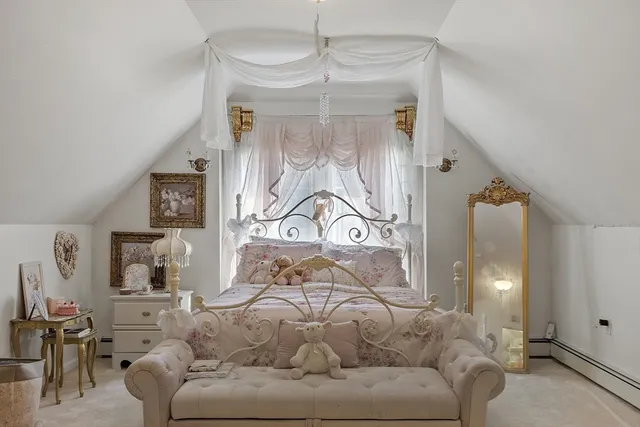 a view of a bedroom with a bed and a desk