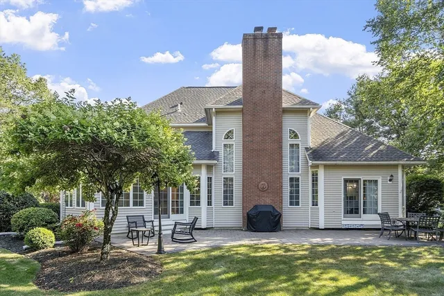 a view of a chairs and table in backyard of the house